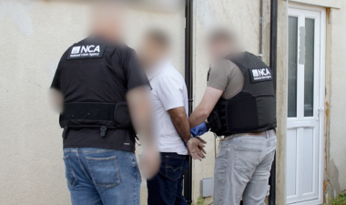 NCA officers arresting a man in a white top